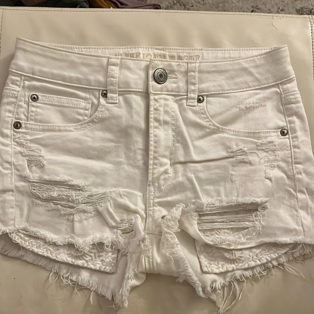 Distressed white denim shorts